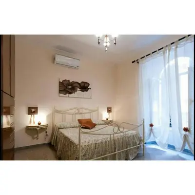 a bedroom with two beds and a window at Domus Ines Roma San pietro in Rome
