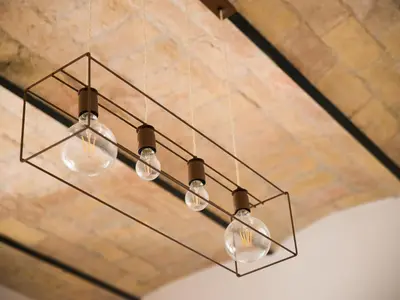 a chandelier with four lights hanging from a ceiling at Domus Claudi Colosseum in Rome