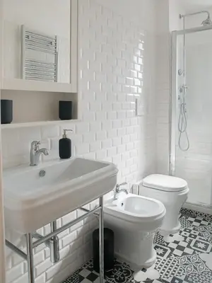 a white bathroom with a sink and a toilet at Domus Claudi Colosseum in Rome