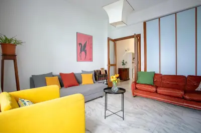 a living room with two couches and a table at Perfetto per Famiglie Appartamento Accogliente e Spazioso a 15 min dalla Metro in Rome