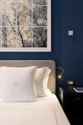 a bedroom with a bed with a picture on the wall at Elizabeth Unique Hotel | a Member of Design Hotels™ in Rome