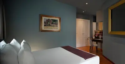 a bedroom with a white bed and a table at Elizabeth Unique Hotel | a Member of Design Hotels™ in Rome