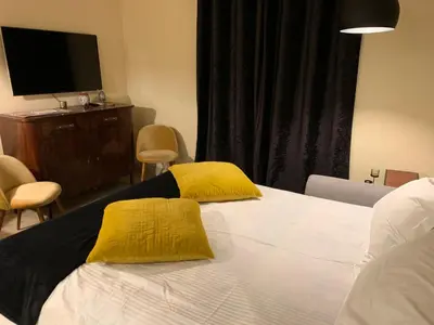 a bedroom with a bed with two yellow pillows on it at Sweethome Crispi in Rome
