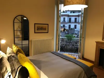 a bedroom with a bed and a large window at Sweethome Crispi in Rome