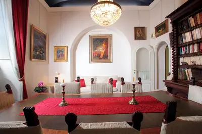a living room with a table with a red rug at Appartamento d'epoca Colosseo Art Gallery in Rome