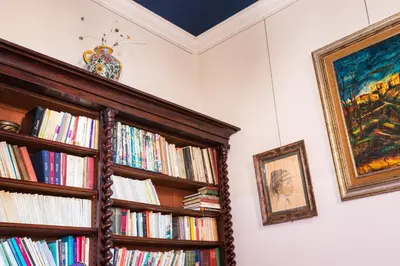 a book shelf full of books in a room at Appartamento d'epoca Colosseo Art Gallery in Rome