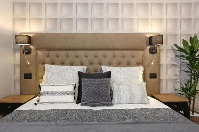 a bedroom with a large bed with pillows at Capricci Romani in Rome
