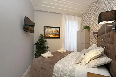 a bedroom with a bed with towels on it at Capricci Romani in Rome