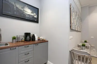 a kitchen with white cabinets and a counter top at Capricci Romani in Rome