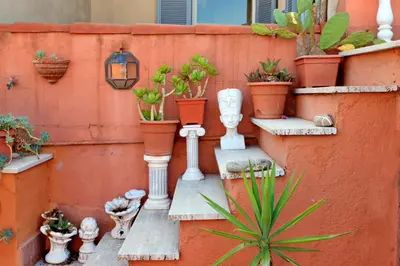 a bunch of plants in pots on a wall at Vicolo del Cinque Penthouse | Romeloft in Rome