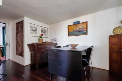a living room with a desk and a table at Vicolo del Cinque Penthouse | Romeloft in Rome