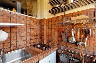 a tiled kitchen with a sink and a counter top at Vicolo del Cinque Penthouse | Romeloft in Rome