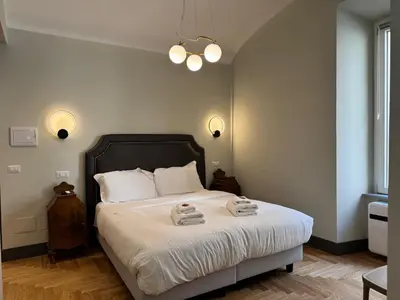 a bedroom with a bed with two towels on it at Santa Monica Townhouse in Rome