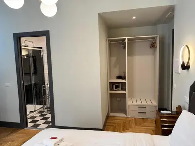 a room with a bed and a bathroom with a mirror at Santa Monica Townhouse in Rome