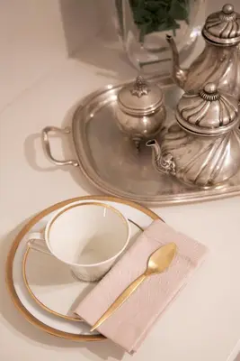 a plate with a cup and a spoon on a table at Santa Monica Townhouse in Rome