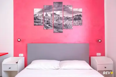 a room with a pink wall at Viale Giulio Cesare Guest House in Rome
