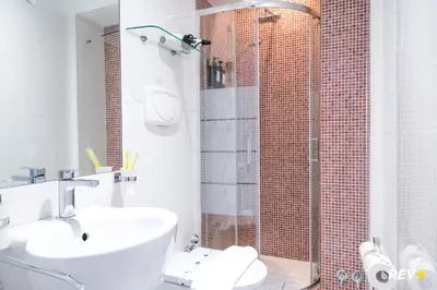 a bathroom with a sink and a glass shower at Viale Giulio Cesare Guest House in Rome