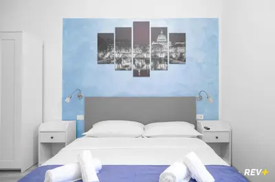 a bedroom with a bed and a blue wall at Viale Giulio Cesare Guest House in Rome