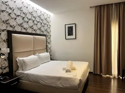 a hotel room with a bed with a towel on it at Catone District Hotel in Rome