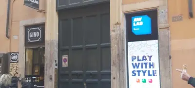 a sign that says play with style in front of a building at Rose Roma in Rome