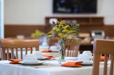 a table with a vase of flowers on a table at Villa Angelina in Rome