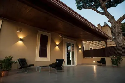 a patio of a house with chairs and lights at Villa Angelina in Rome