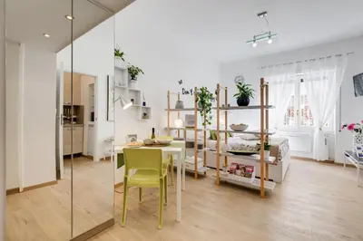 a living room with a table and a dining room at Vatican 96 Degli Ubaldi Studio steps from metro and St Peter's in Rome