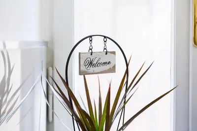a welcome sign hanging from a door in a room at Vatican 96 Degli Ubaldi Studio steps from metro and St Peter's in Rome