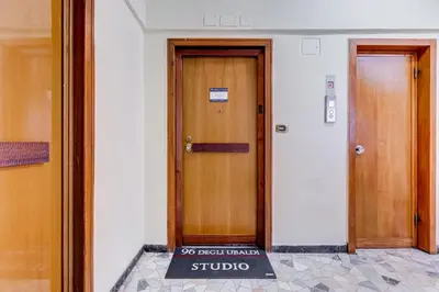 two doors in a building with a sign in front of it at Vatican 96 Degli Ubaldi Studio steps from metro and St Peter's in Rome