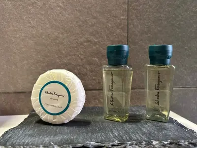 two bottles of essential oils sitting next to a plate at Charming Roma in Rome