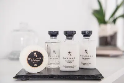 a group of four bottles of perfume on a counter at Charming Roma in Rome