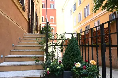 a set of stairs in front of a building with flowers at Charming Roma in Rome