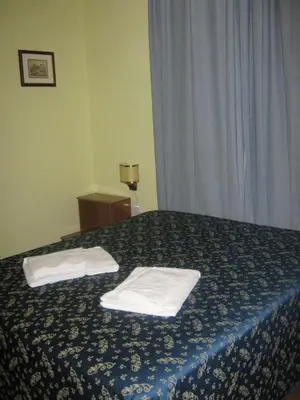 a hotel room with a bed with towels on it at Hotel Ferraro in Rome