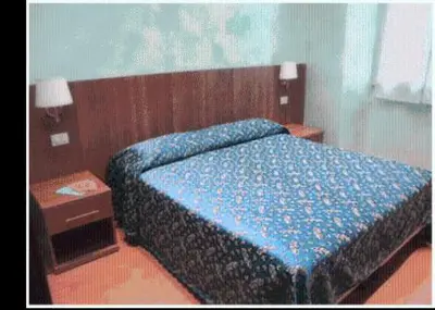 a bedroom with a blue bed with a wooden headboard at Hotel Ferraro in Rome