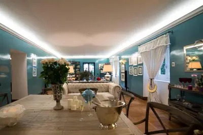 a living room with a table and a couch at Hotel Villa Linneo in Rome