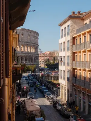 a busy city street with the leaning tower of coliseum at Colosseo Guest House in Rome