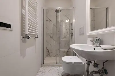 a sink with a faucet and a bowl of fruit on it at Colosseo Guest House in Rome