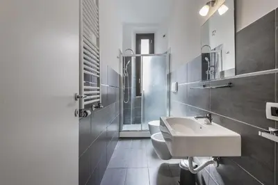 a bathroom with a toilet and a sink and a shower at Colosseo Guest House in Rome