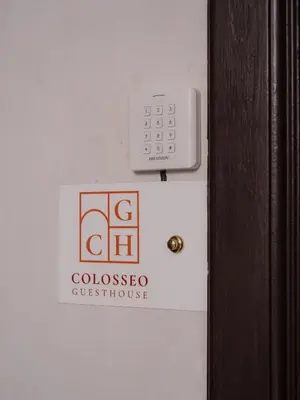 a person holding a cell phone in their hand at Colosseo Guest House in Rome