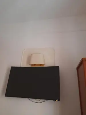 a flat screen tv on a wall with a lamp at Incantoromano guest house in Rome
