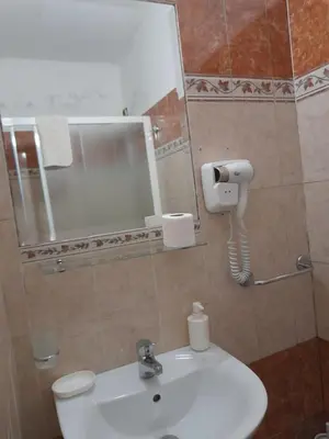 a bathroom with a sink and a mirror and a toilet at Incantoromano guest house in Rome