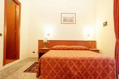 a bedroom with a bed and a wooden head board at Incantoromano guest house in Rome