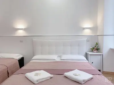 a bedroom with two beds with towels on them at Golden Ratio in Rome