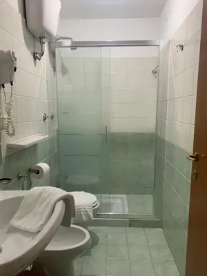a bathroom with a shower and a toilet and a sink at Golden Ratio in Rome