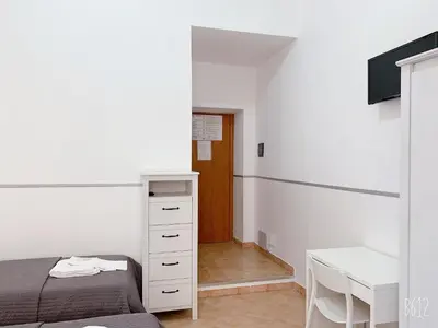 a bedroom with a bed and a desk and a table at Golden Ratio in Rome