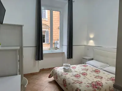 a small bedroom with a bed and a window at Golden Ratio in Rome