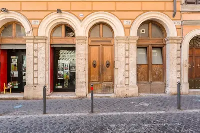 a building with large wooden doors on a street at Monti Colosseum apartment in Rome