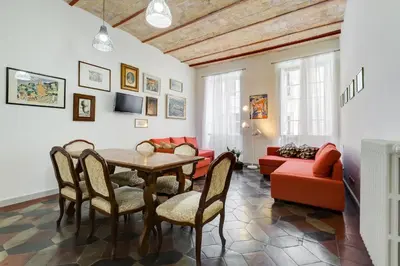 a living room with a table and chairs and a couch at Monti Colosseum apartment in Rome