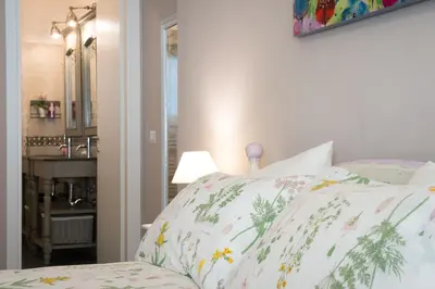 a bedroom with a bed with floral pillows at Magnolia St.Peter's Suites in Rome
