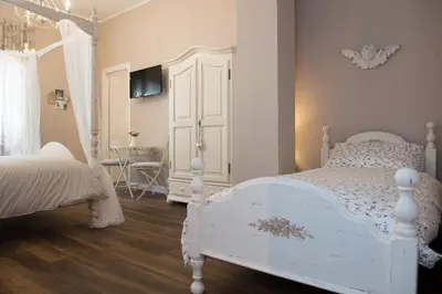 a bedroom with a white bed and a white door at Magnolia St.Peter's Suites in Rome